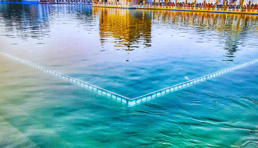 lose-up view of the Golden Temple reflecting in the holy sarovar pool.