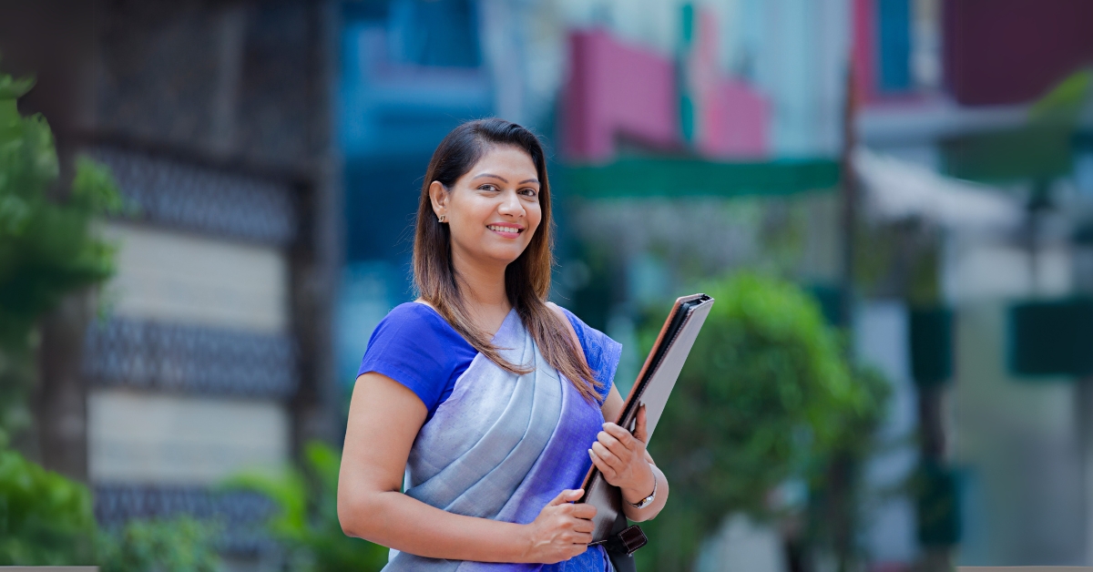 A professional Indian Girl standing in front of a corporate office building in United States.